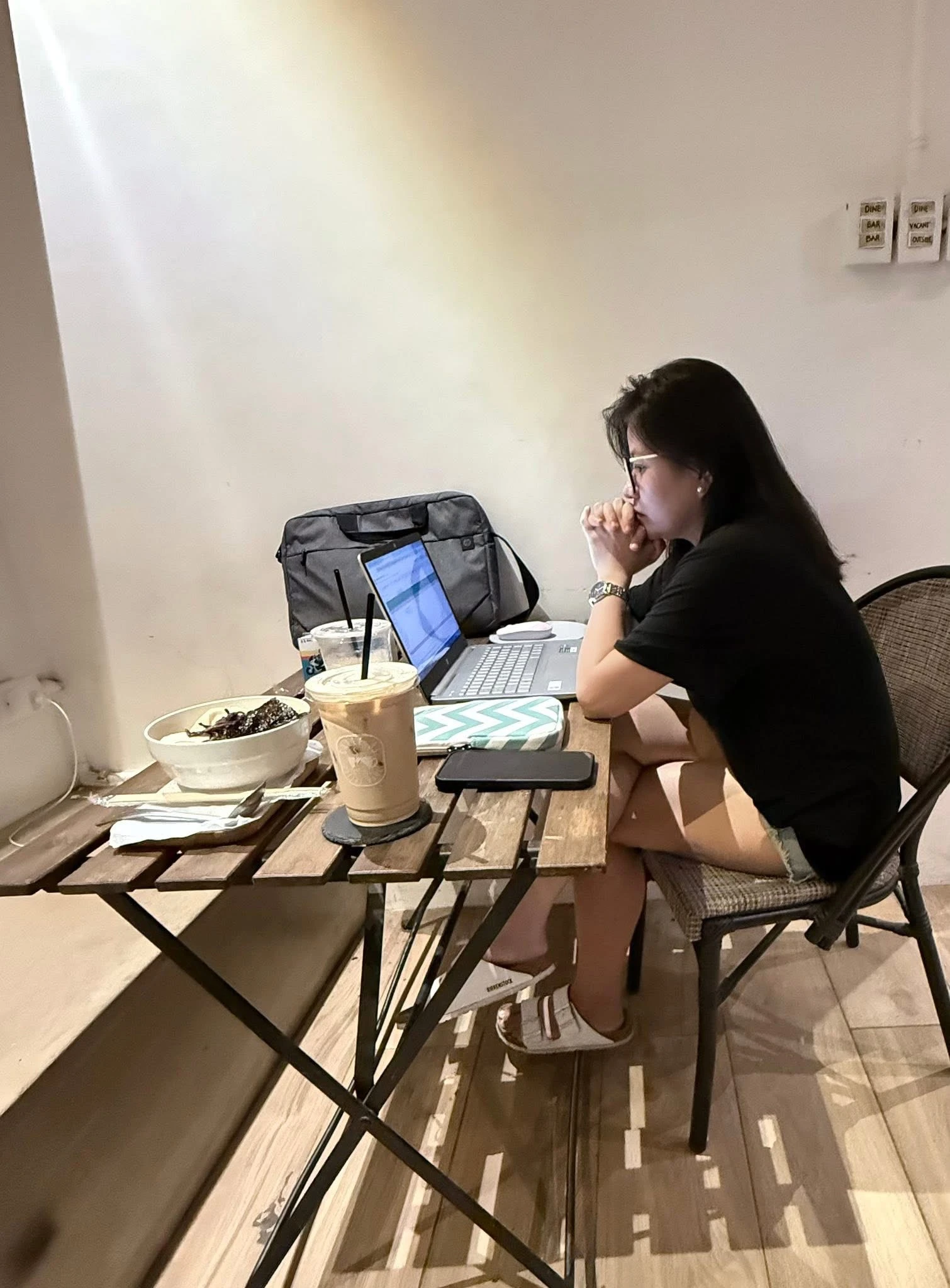 SEO specialist working on a laptop during a coffee session in her hometown